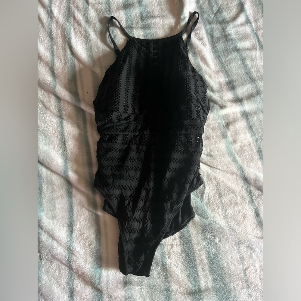 woman’s black laced one piece bathing suit